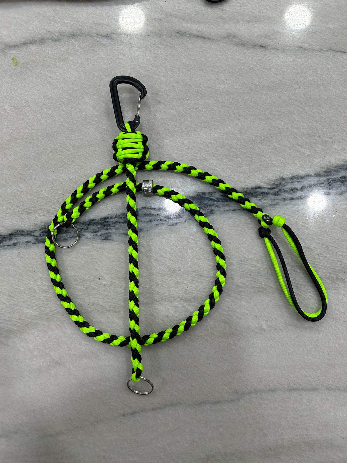 Braided neon green and black paracord key lanyard with a black carabiner clip and kill switch.