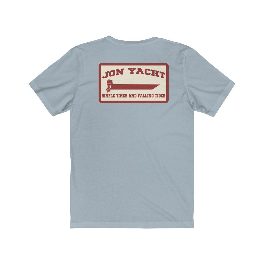 Light blue soft cotton jersey tee with "Jon Yacht" boat graphic and "Simple Times and Falling Tides" text on back.