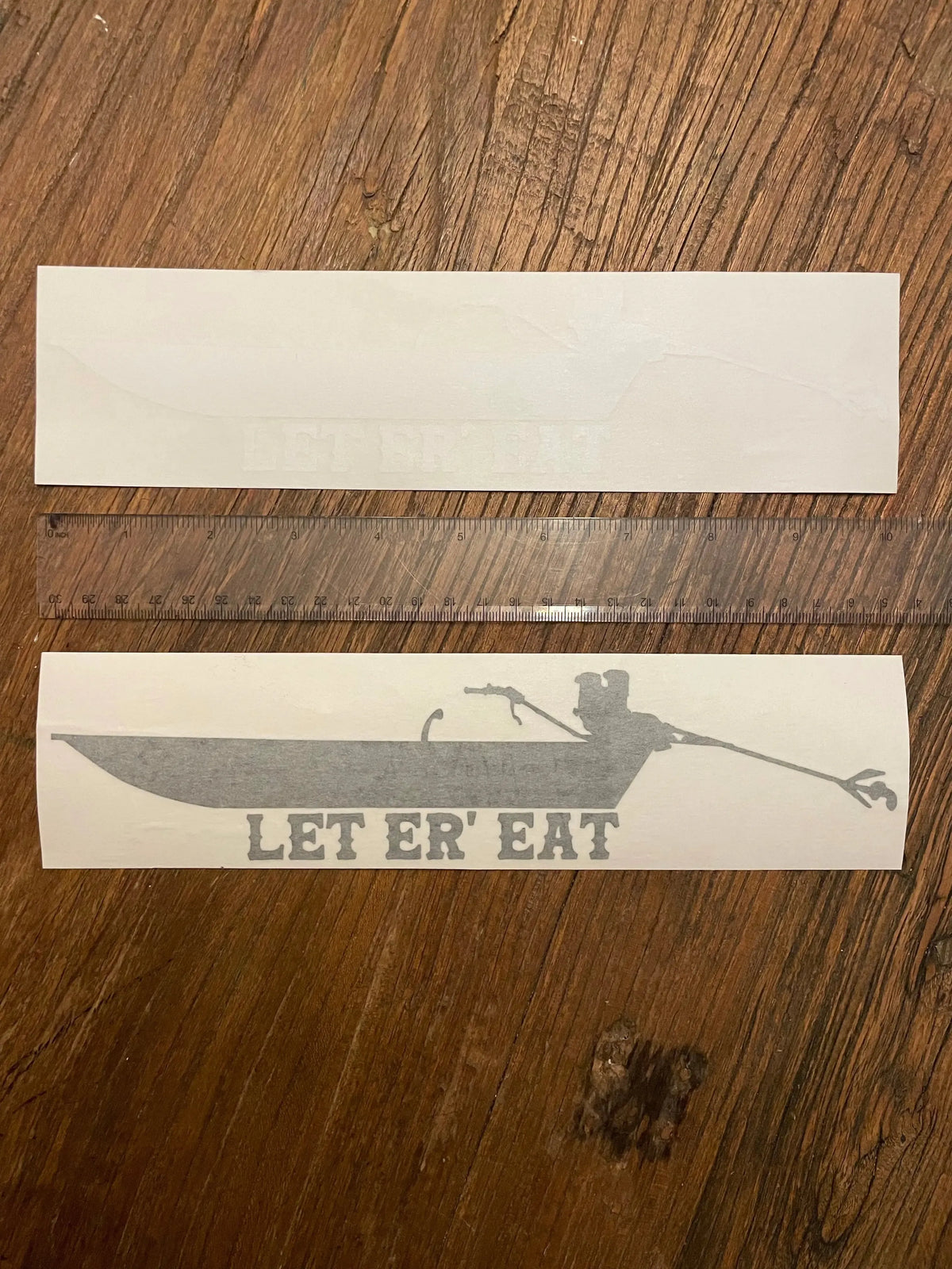 Gray "Let er Eat" 10" vinyl transfer sticker featuring a long tail mud motor boat design.