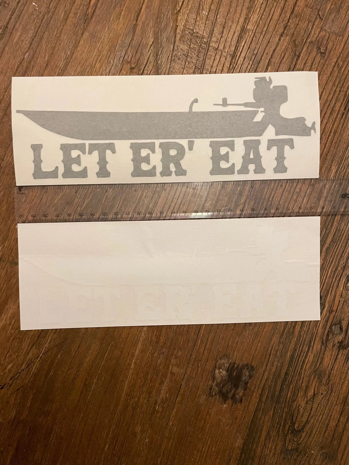 Gray 10" vinyl transfer sticker with "LET ER' EAT" text and a boat design.