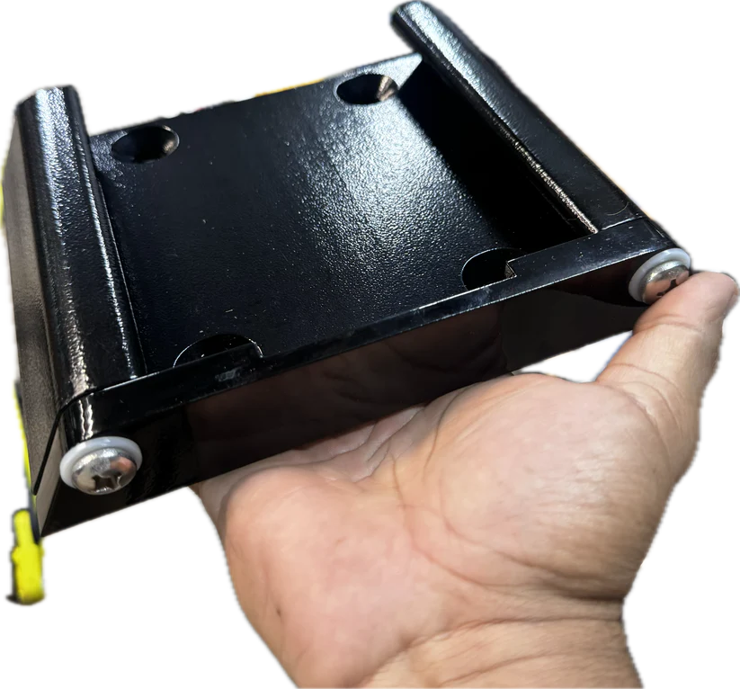 Hand holding a black powder-coated Lewmar Axis quick release mount with two silver screws.