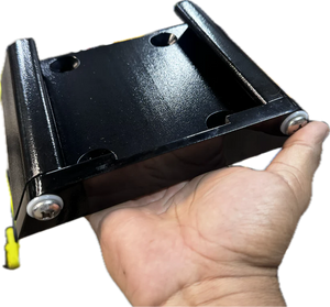 Hand holding a black powder-coated Lewmar Axis quick release mount with two silver screws.