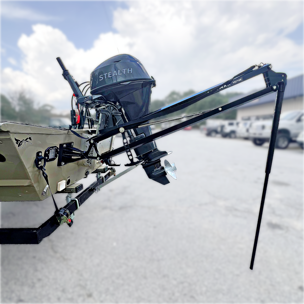 Black Lewmar Vector manual shallow water anchor mounted on a tan jon boat transom with a black outboard.