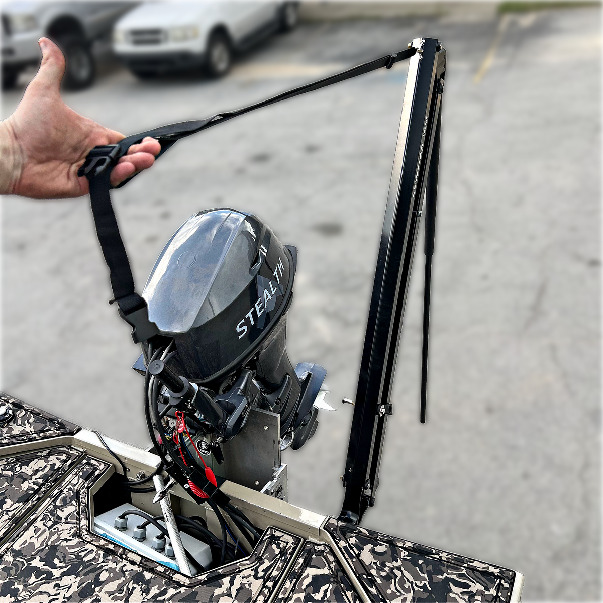 Black Lewmar Vector manual shallow water anchor on a camo jon boat transom, next to a "STEALTH" outboard.