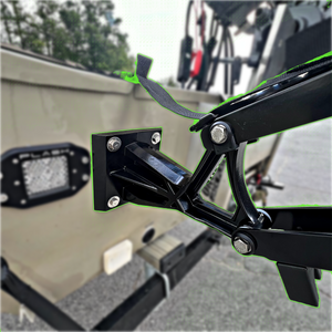 Black Lewmar Vector manual shallow water anchor mounted on a tan boat transom.