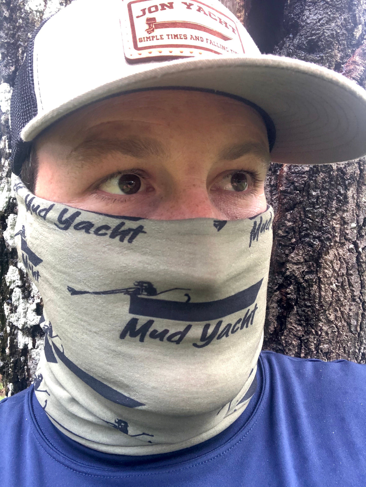 OD green Long Tail mud yacht buff with black logo on a person's face.