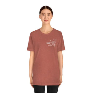 Woman wearing a heather clay cotton tee with a white MERC Tiller graphic on the left chest.