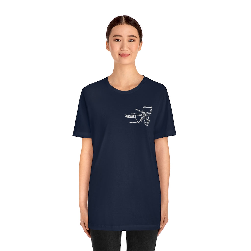 Woman wearing a navy MERC Tiller short sleeve tee with a white outboard motor graphic.