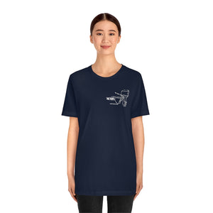 Woman wearing a navy MERC Tiller short sleeve tee with a white outboard motor graphic.