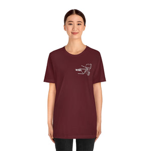 Woman wearing a maroon MERC Tiller graphic tee made from soft Airlume combed and ringspun cotton.
