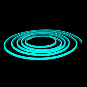 Coiled MINI LED Neon Flex glowing bright aqua blue against a dark background.