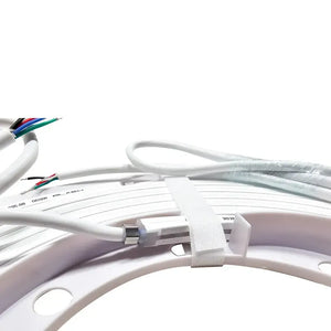 Coiled white MINI LED Neon Flex RGBW strip with exposed multi-color wires, secured with a white strap.