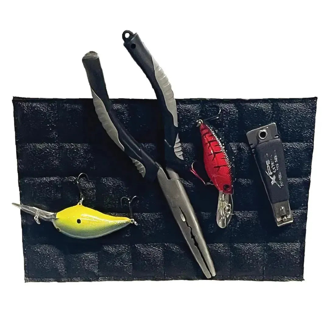 Black Magnalure Pad holding fishing pliers, a yellow lure, a red lure, and snips.