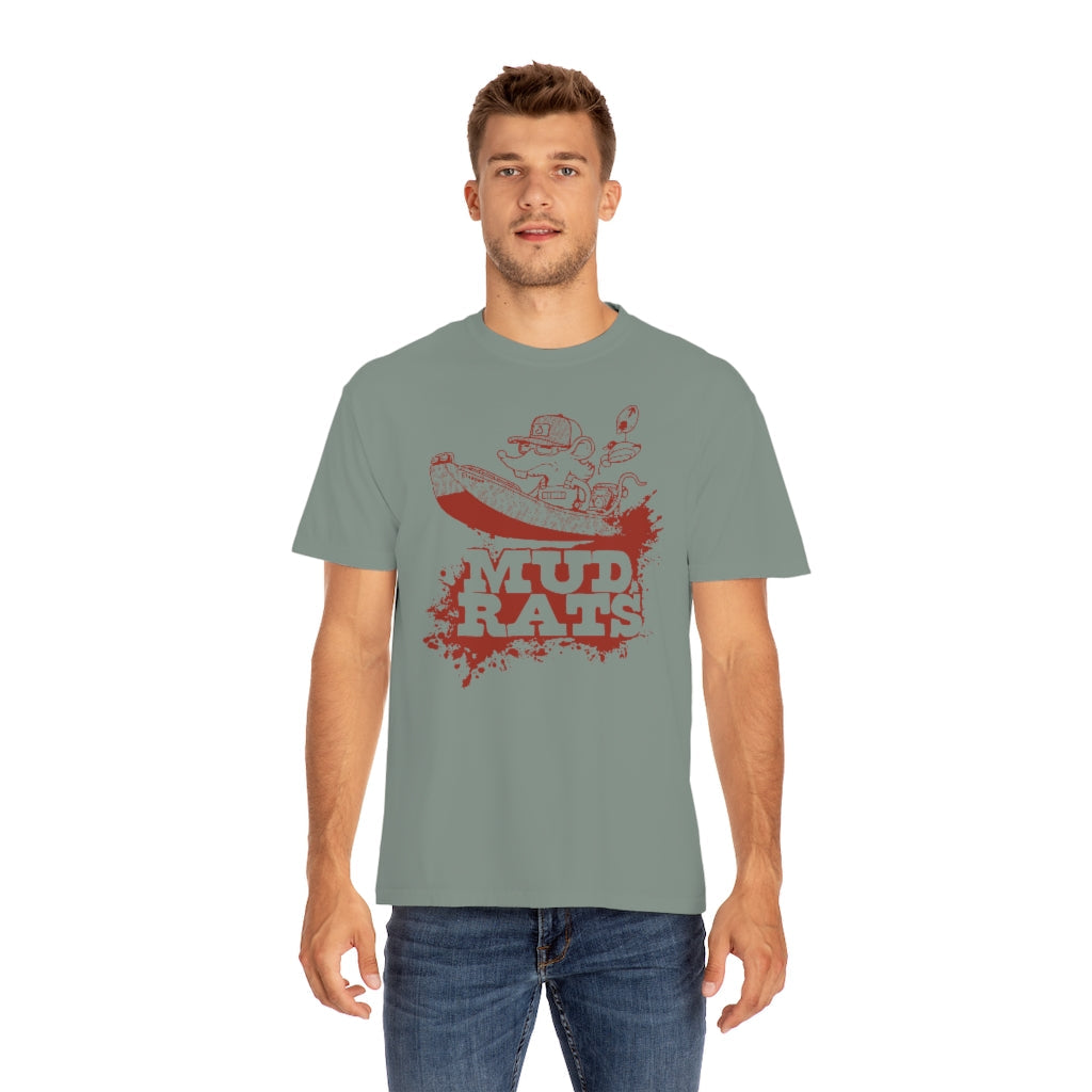 Man wearing a relaxed fit, garment-dyed sage green Mud Rats T-shirt with a red rat driving a boat design.