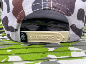 Mud Yacht camo rope hat with a beige snapback closure and black Jon Yacht tag.