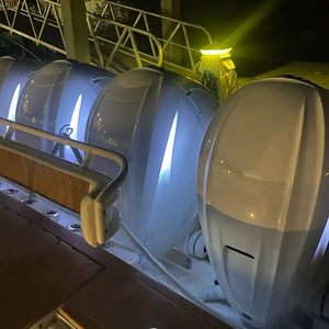 White Mercury 450 outboard engines with bright white Neon Flex LED strips illuminating the cowlings at night.