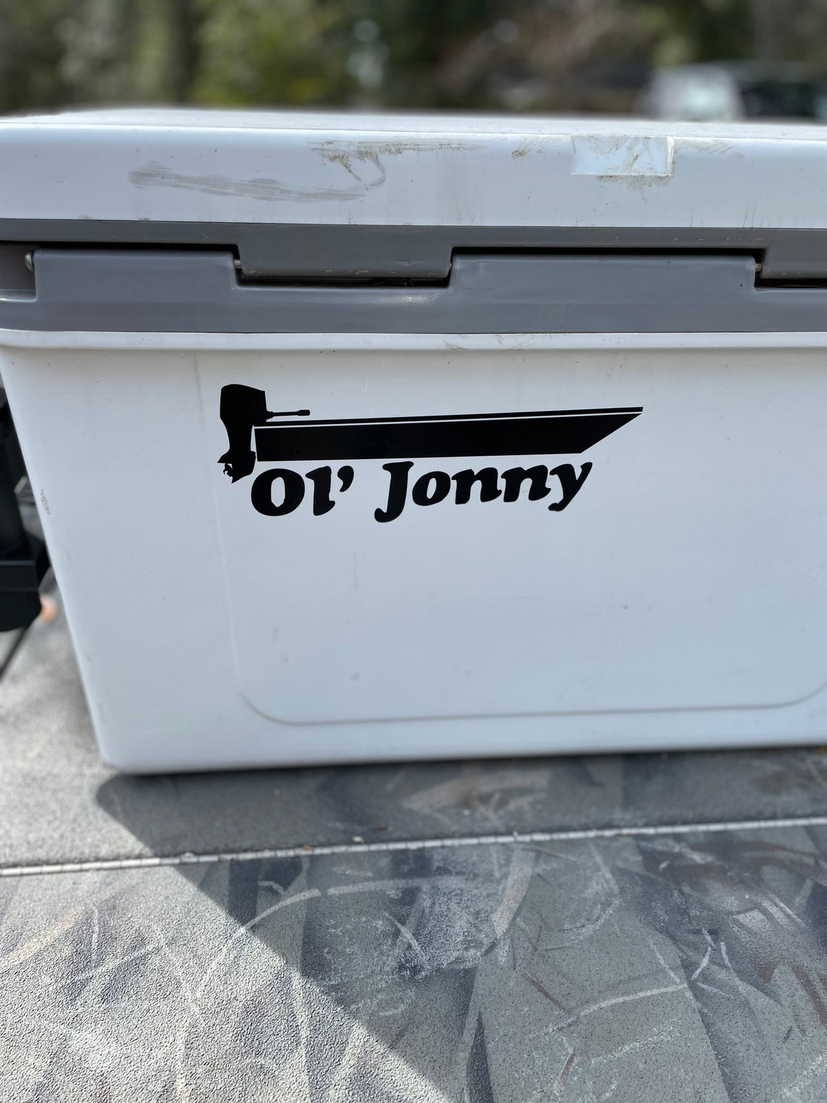 Black "Ol' Jonny" 10" vinyl boat decal on a white cooler.