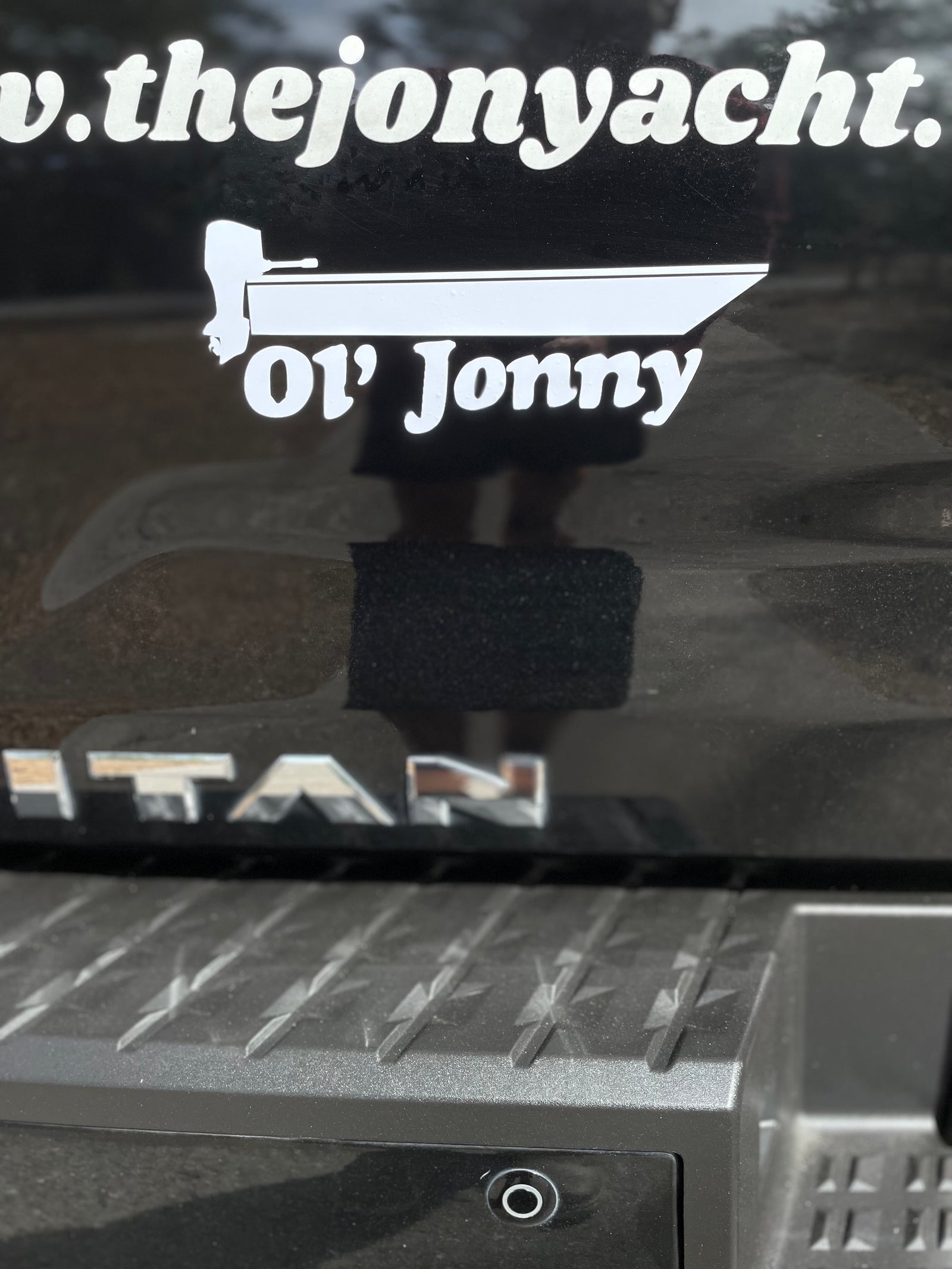 Black "Ol' Jonny" 10" vinyl boat decal on a white cooler.