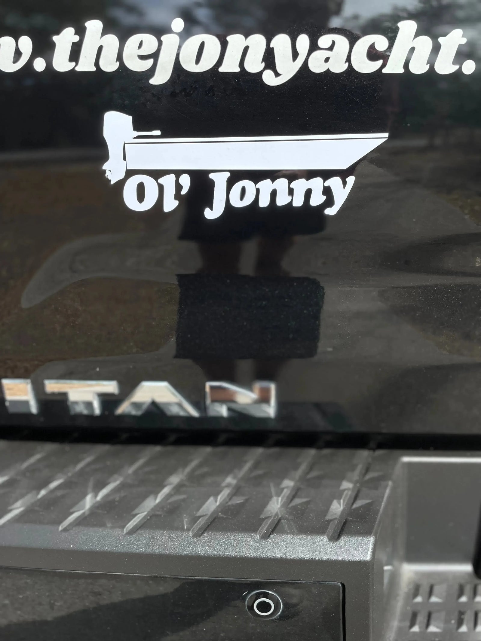 Black "Ol' Jonny" 10" vinyl boat decal on a white cooler.