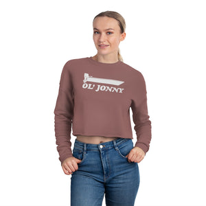 Woman in a brown "Ol' Jonny" cropped sweatshirt with a boat graphic and blue jeans.