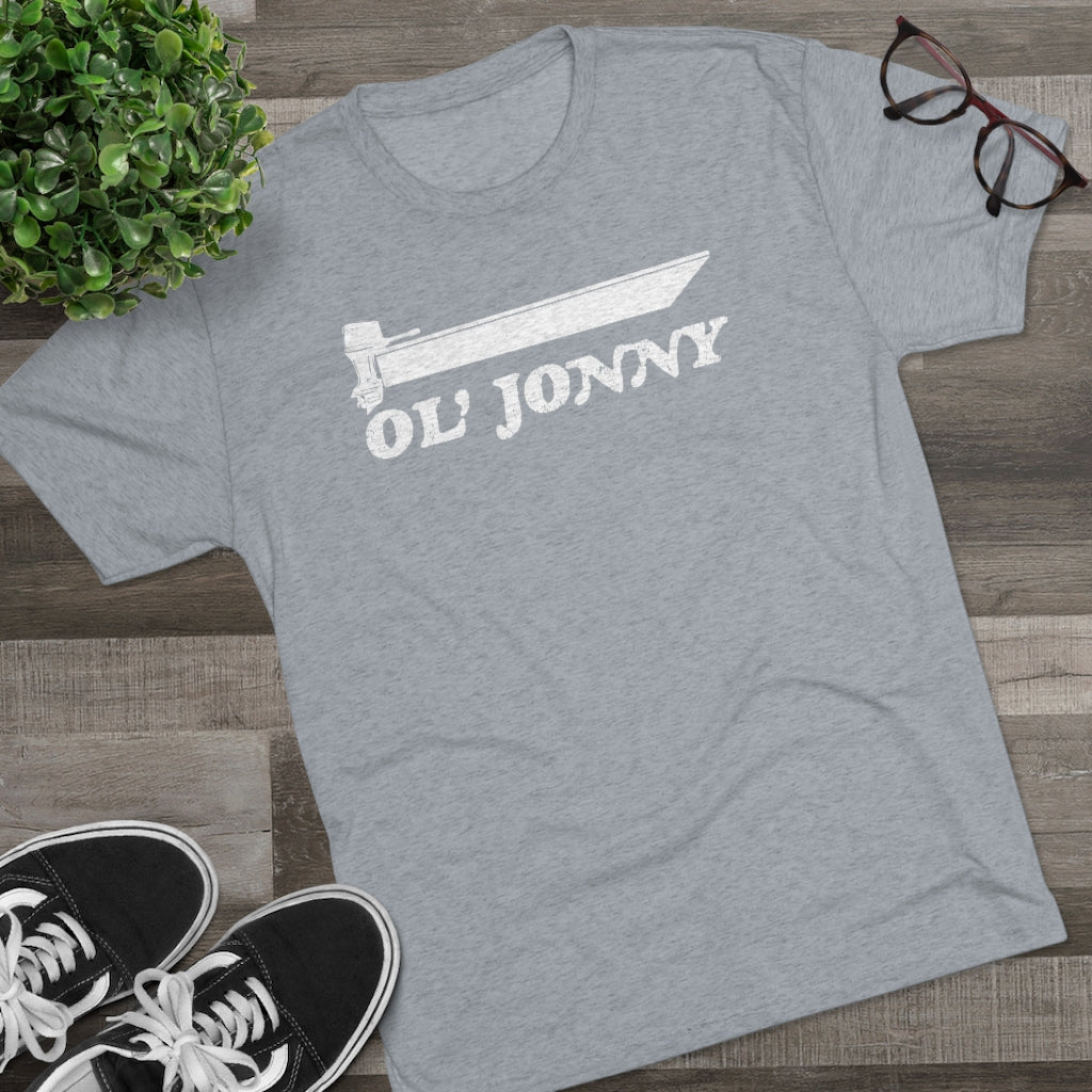 Light grey tri-blend tee with "Ol' Jonny" boat graphic, black sneakers, and glasses on wood.