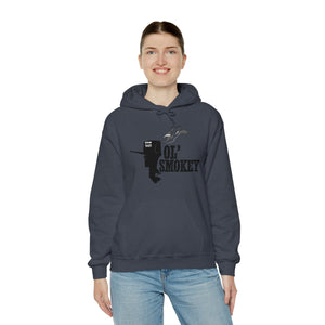 Woman smiling in a dark gray Ol' Smokey Hoodie with a 2-stroke engine graphic.