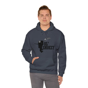 Man wearing a charcoal gray Ol' Smokey Hoodie with a black graphic of a smoking engine.