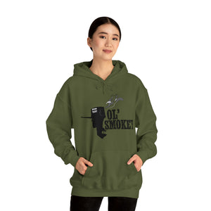 Woman wearing an olive green Ol' Smokey Hoodie with a 2-stroke engine graphic and front pouch pocket.