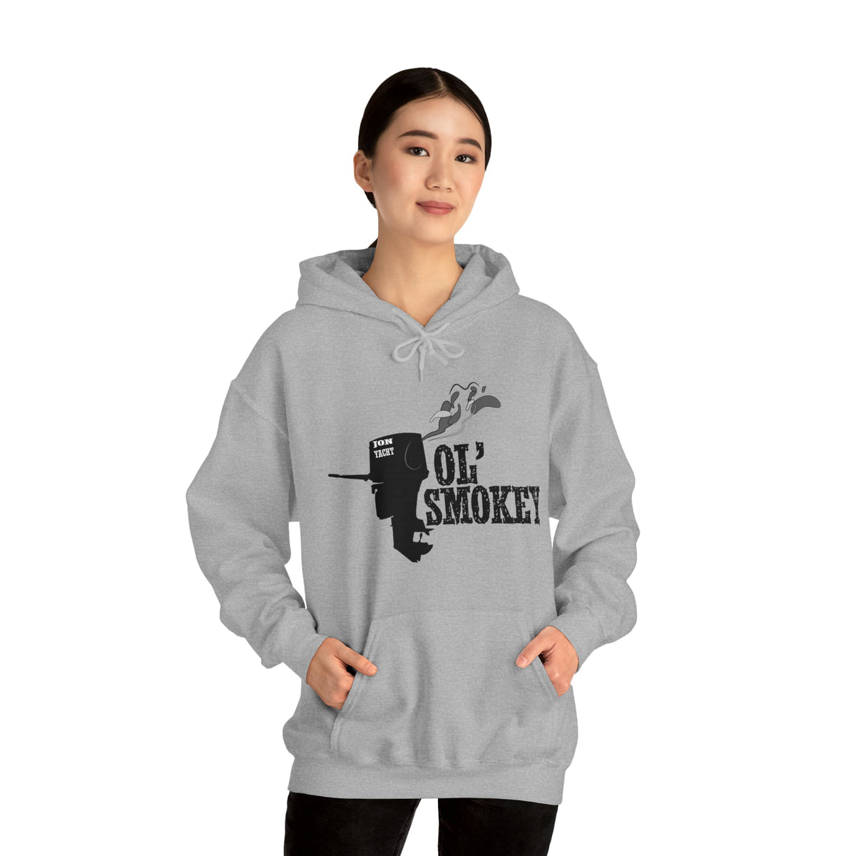Woman wearing a grey Ol' Smokey Hoodie with a black two-stroke engine graphic.