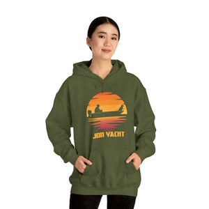 Woman wearing an olive green "Ol Yeller" hoodie with a sunset fishing boat graphic and "JON YACHT" text.