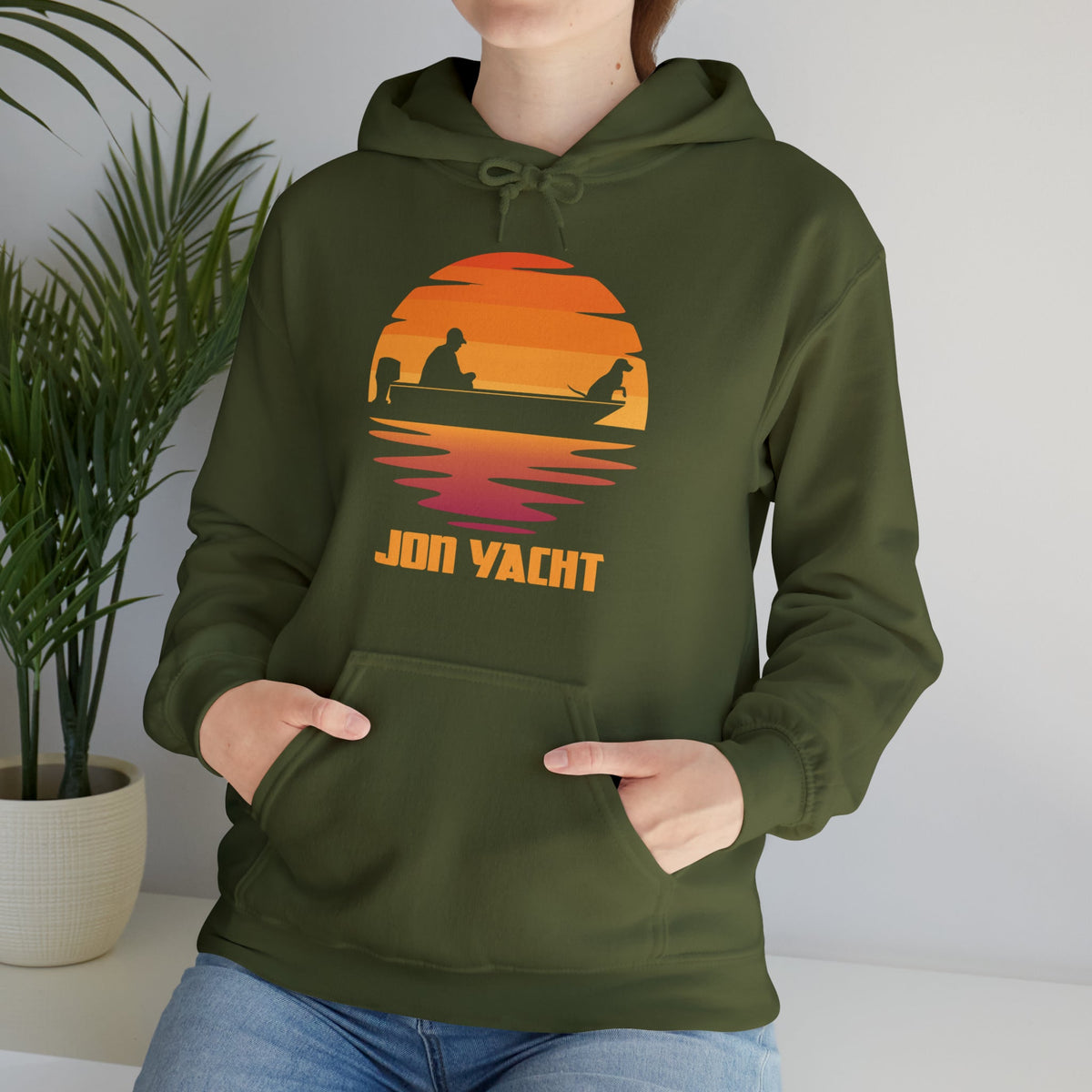 Olive green cotton-polyester hoodie with a sunset graphic featuring a person and dog in a boat, "JON YACHT" text.