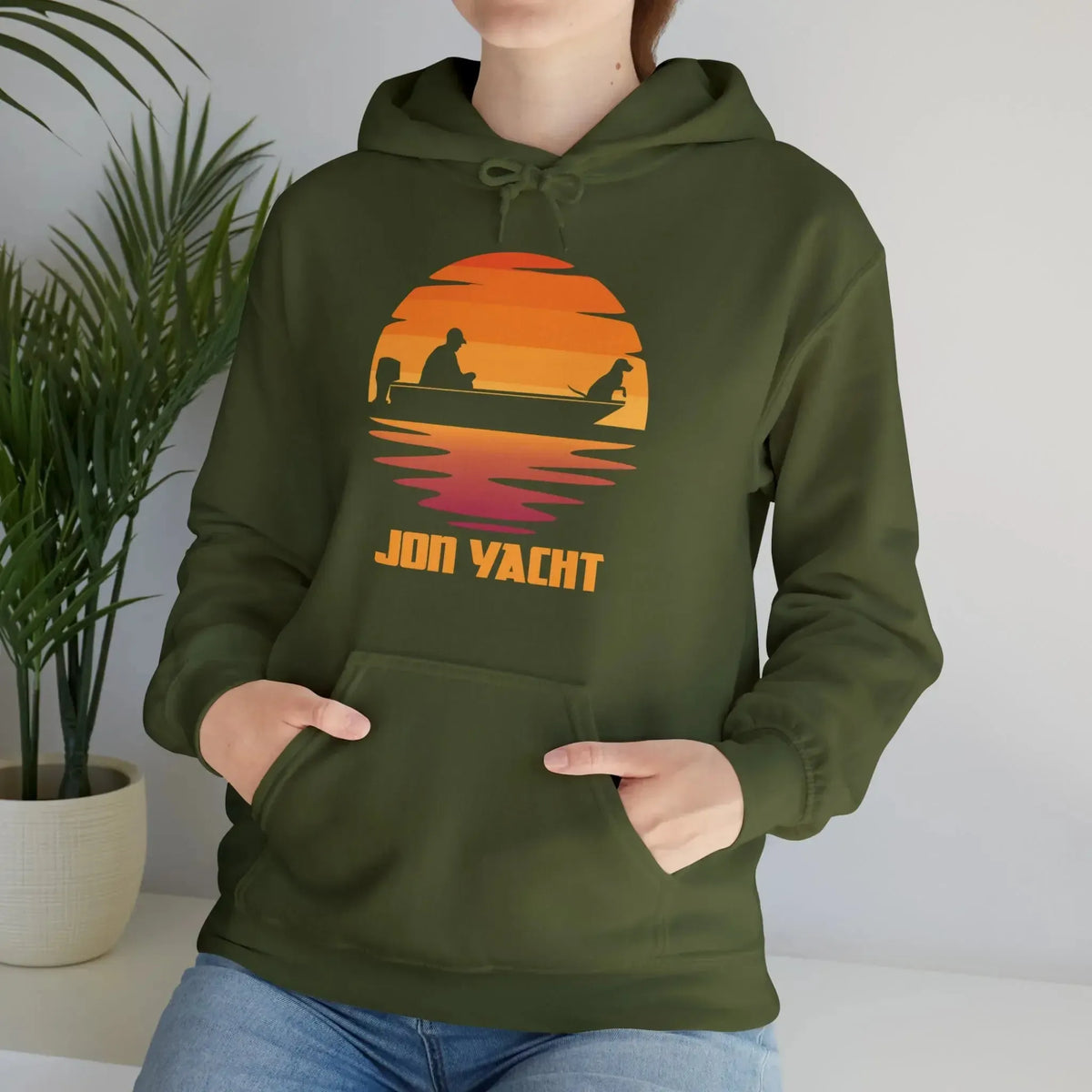 Olive green cotton-polyester hoodie with a sunset graphic featuring a person and dog in a boat, "JON YACHT" text.