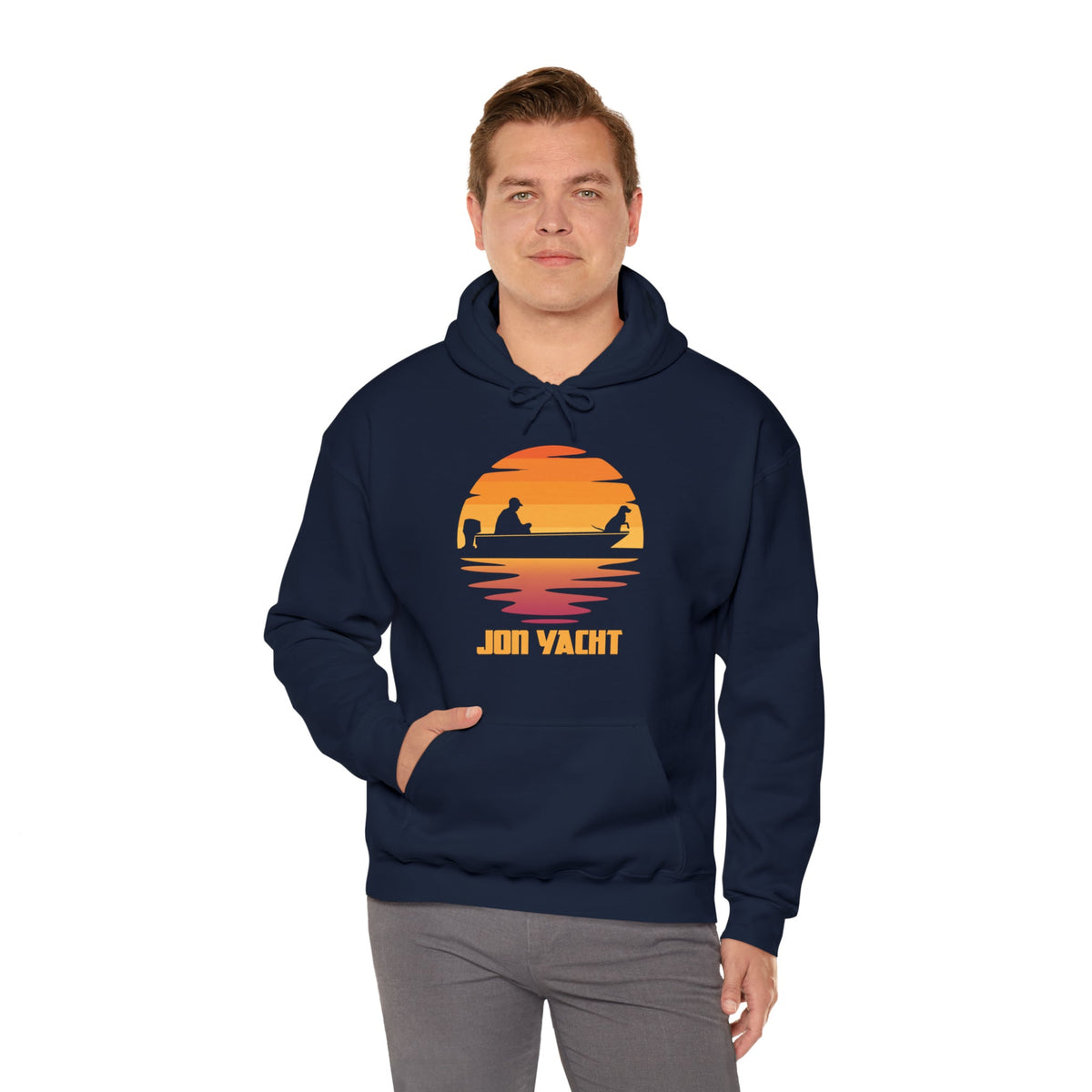 Man wearing a navy blue "Ol Yeller" hoodie with a sunset boat graphic and "JON YACHT" text.