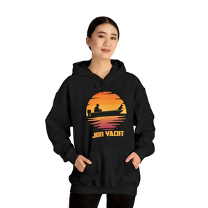 Woman in black hoodie with "Jon Yacht" sunset graphic, kangaroo pocket, and matching drawstring.