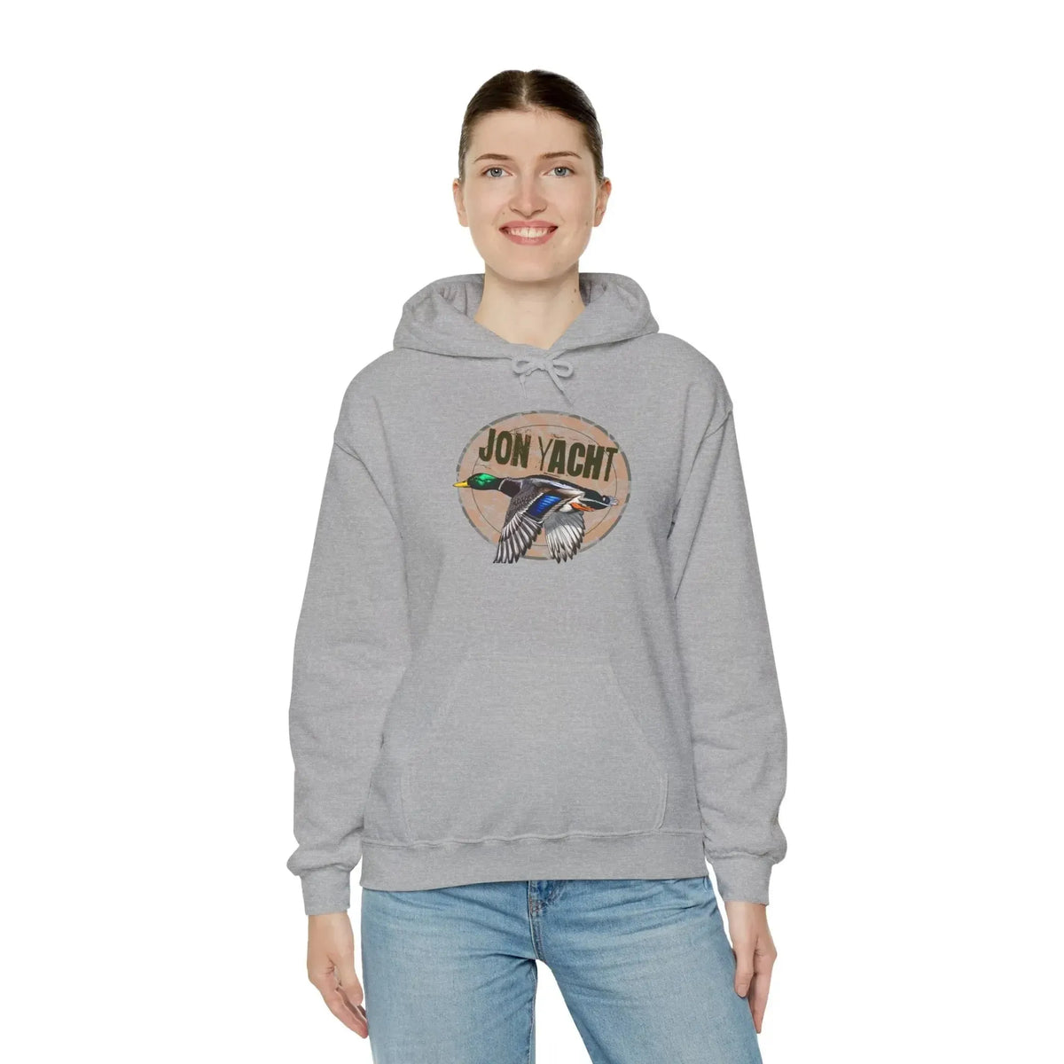 Woman wearing a gray cotton-polyester hoodie with a "JON YACHT" logo and a flying duck graphic.