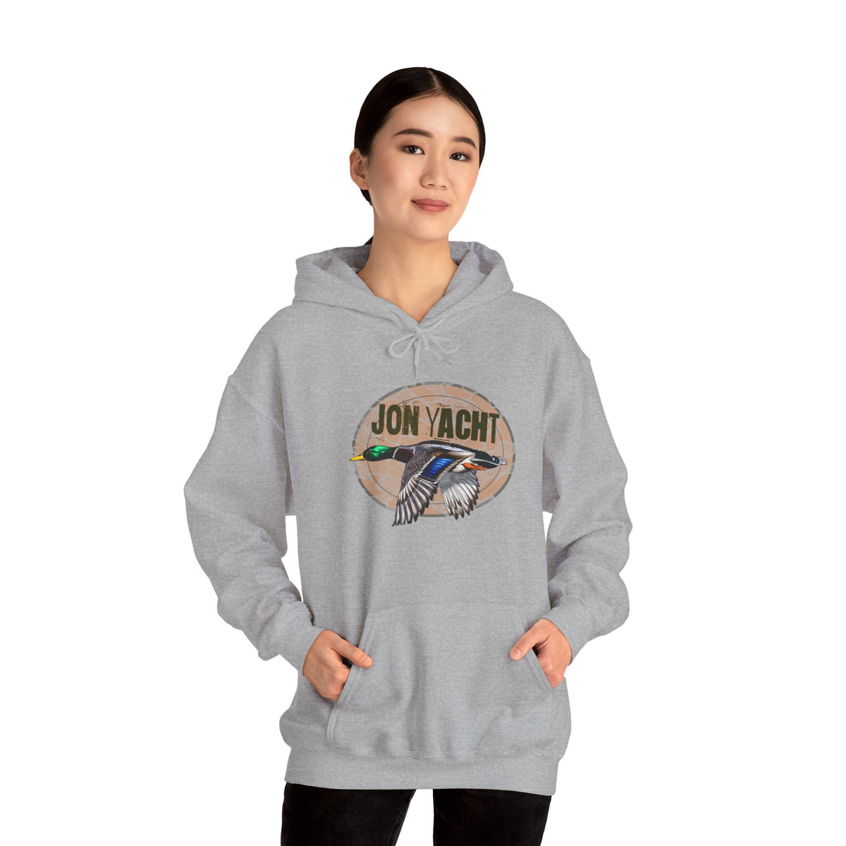 Woman wearing a gray cotton-polyester hoodie with a "JON YACHT" logo and a flying mallard duck graphic.