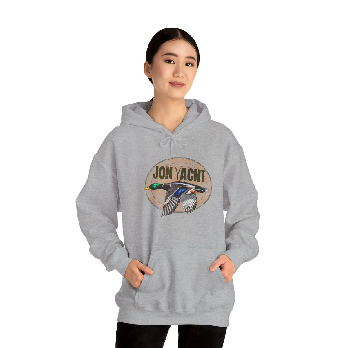 Woman wearing a gray cotton-polyester hoodie with a "JON YACHT" logo and a flying mallard duck graphic.