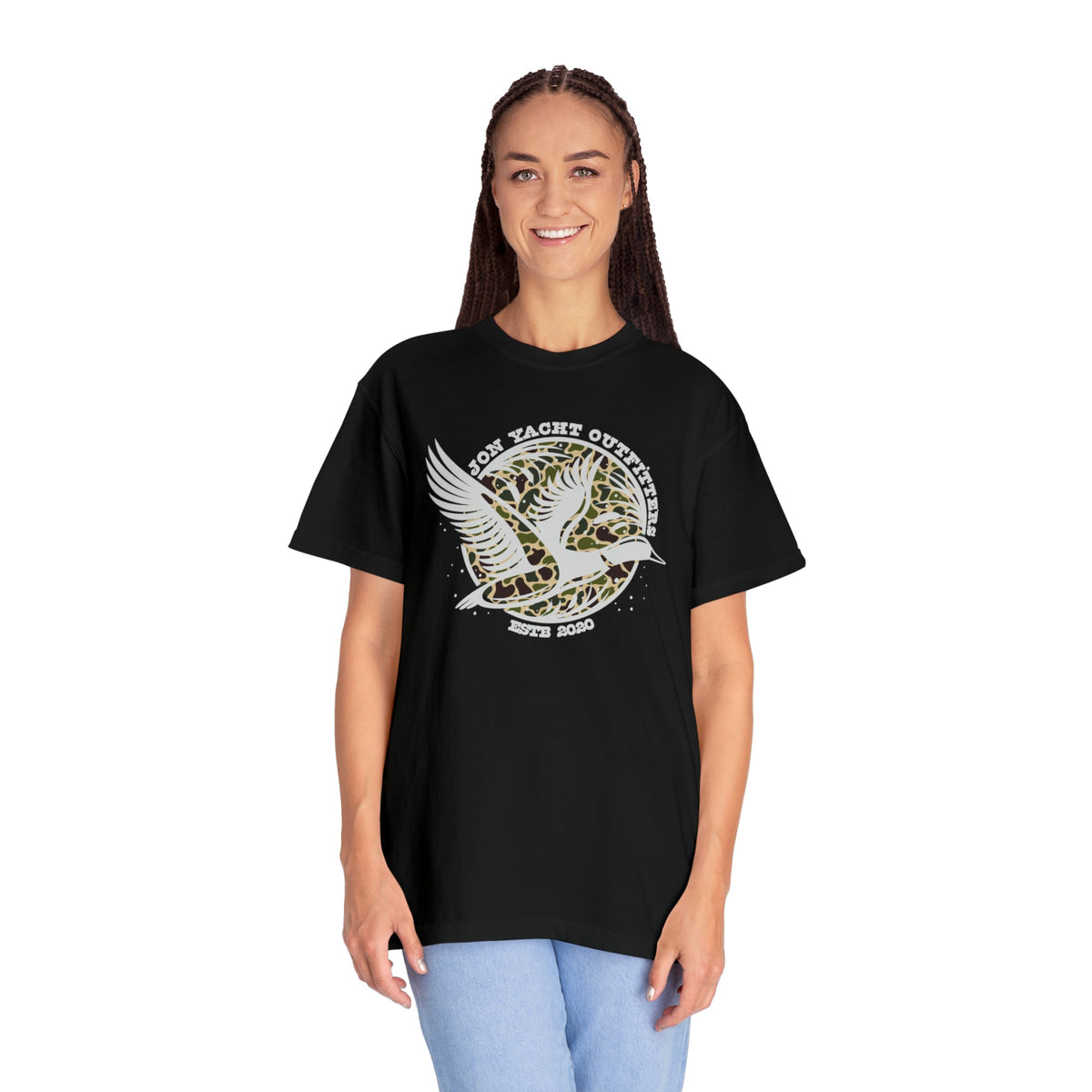 Woman wearing a black Comfort Colors t-shirt with a "Jon Yacht Outfitters" duck design on a leopard print background.