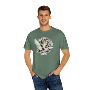 Man in a relaxed fit, garment-dyed green t-shirt with a "Jon Yacht Outfitters" duck graphic.