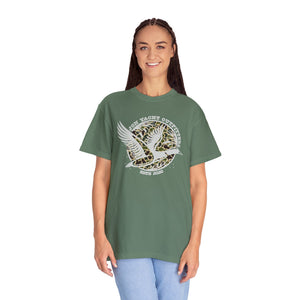 Woman in a relaxed fit, garment-dyed green t-shirt with a "Jon Yacht Outfitters" duck graphic.