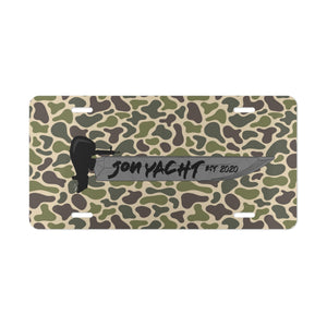 Aluminum license plate with a green and brown camouflage pattern, featuring a black boat and "JON YACHT EST 2020" text.