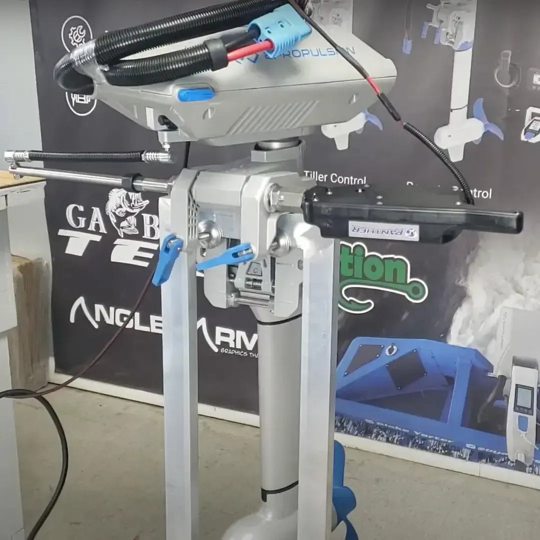Silver Panther T4 Electro Steer kicker motor with black cables and blue connectors, mounted on a stand.