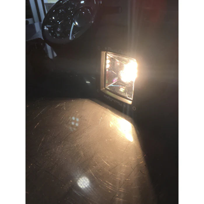 PlashLights 2" 40W warm white fishing cube light illuminated, casting a bright glow.