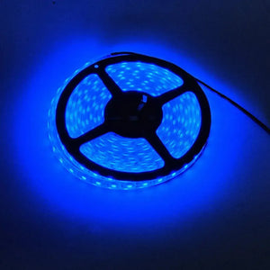 Spool of bright blue LED flexible light strip, glowing intensely in a dark setting.