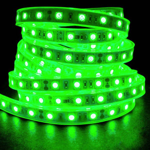 Coiled PlashLights IP68 waterproof flexible LED light strip glowing bright green on a dark background.