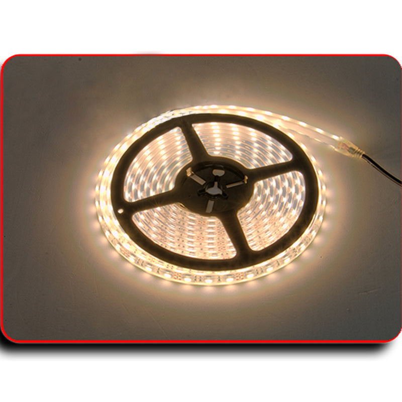 Coiled PlashLights IP68 waterproof flexible LED light strip, emitting warm white illumination.