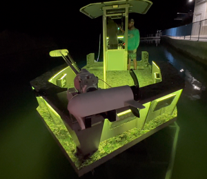 Boat with bright green Plashlights RGBW LED strips illuminating the hull and water at night.