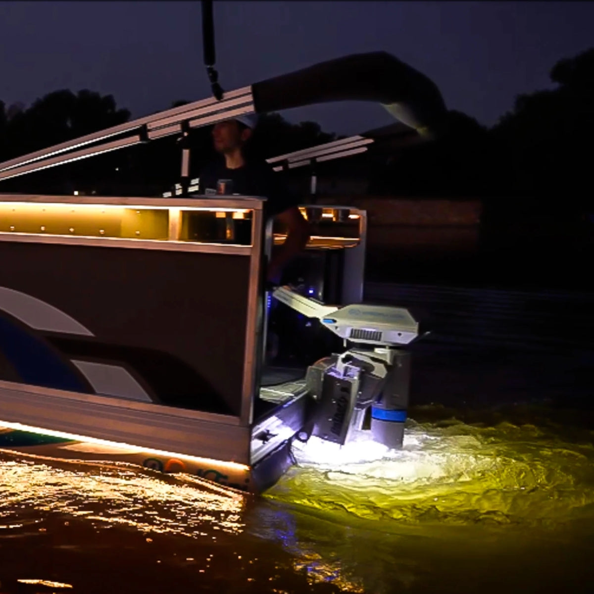 Plashlights EPIK underwater transom lights illuminating water with a brilliant yellow glow from a boat.