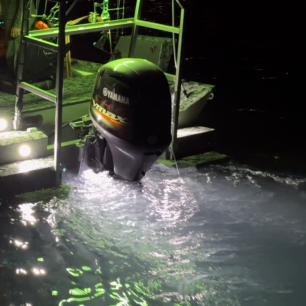 Plashlights EPIK underwater transom lights illuminating water with a brilliant green glow behind a boat.