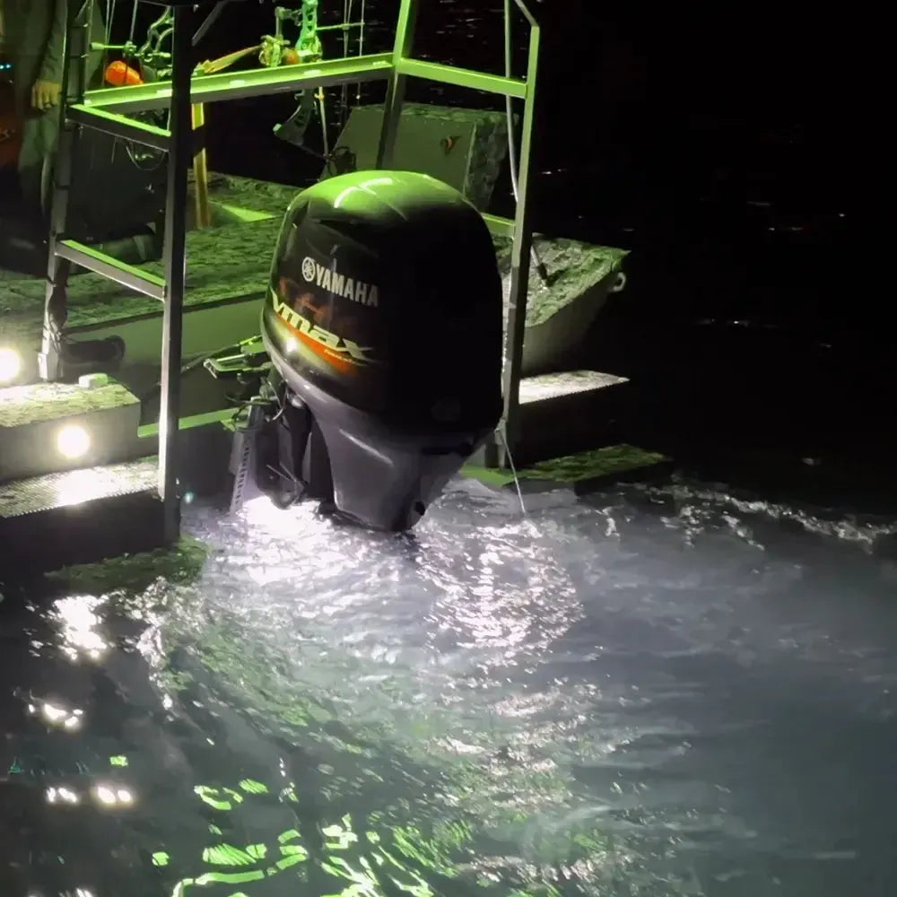 Plashlights EPIK underwater transom lights illuminating water with a brilliant green glow behind a boat.